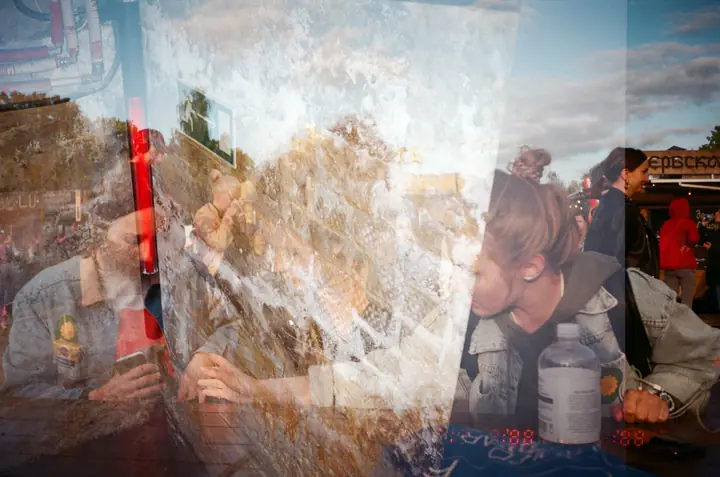 A double exposure of friends at a table